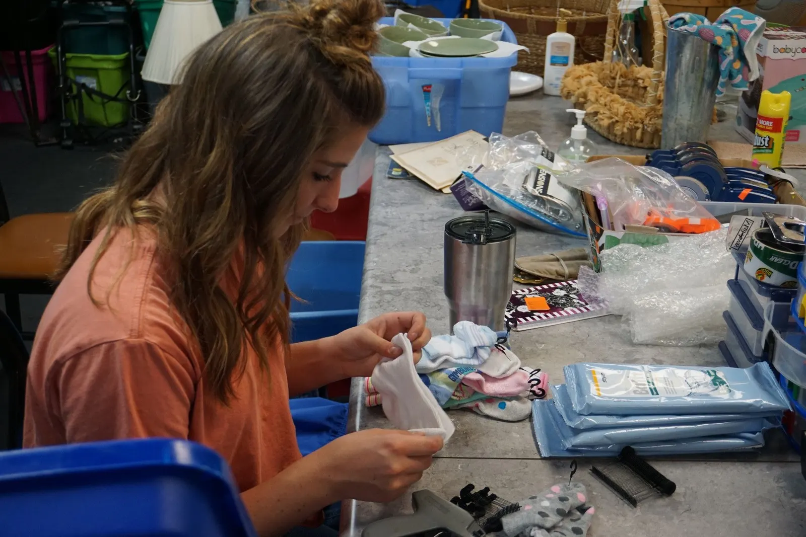A volunteer sorting donated items in the processing room