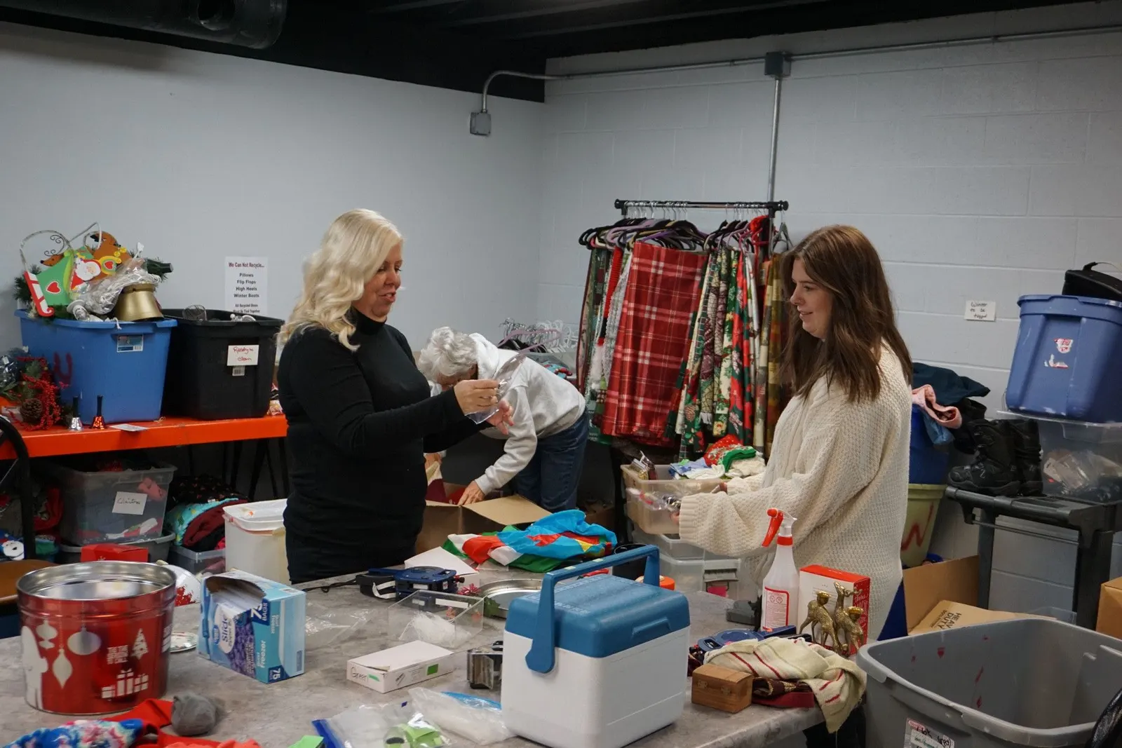 Seek And Find volunteers smiling while sorting donations