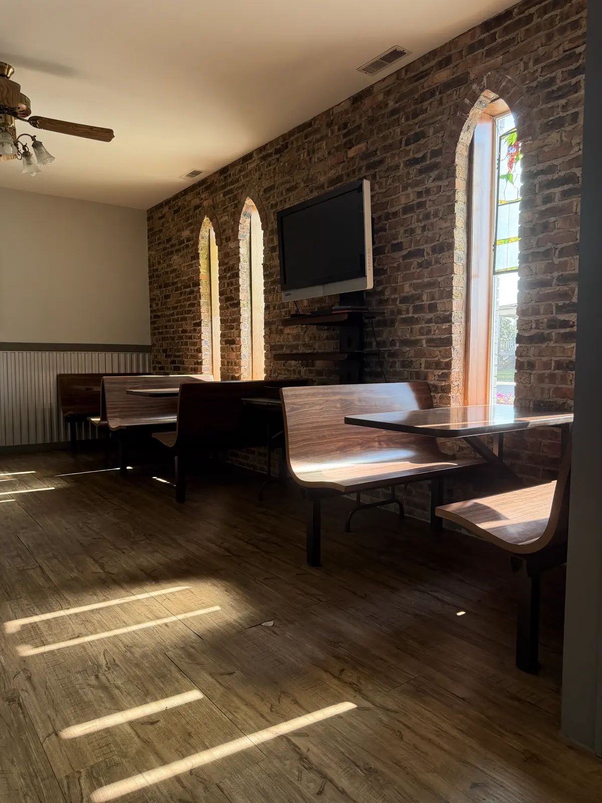 Sunlight through the stained glass windows onto the cafe booths