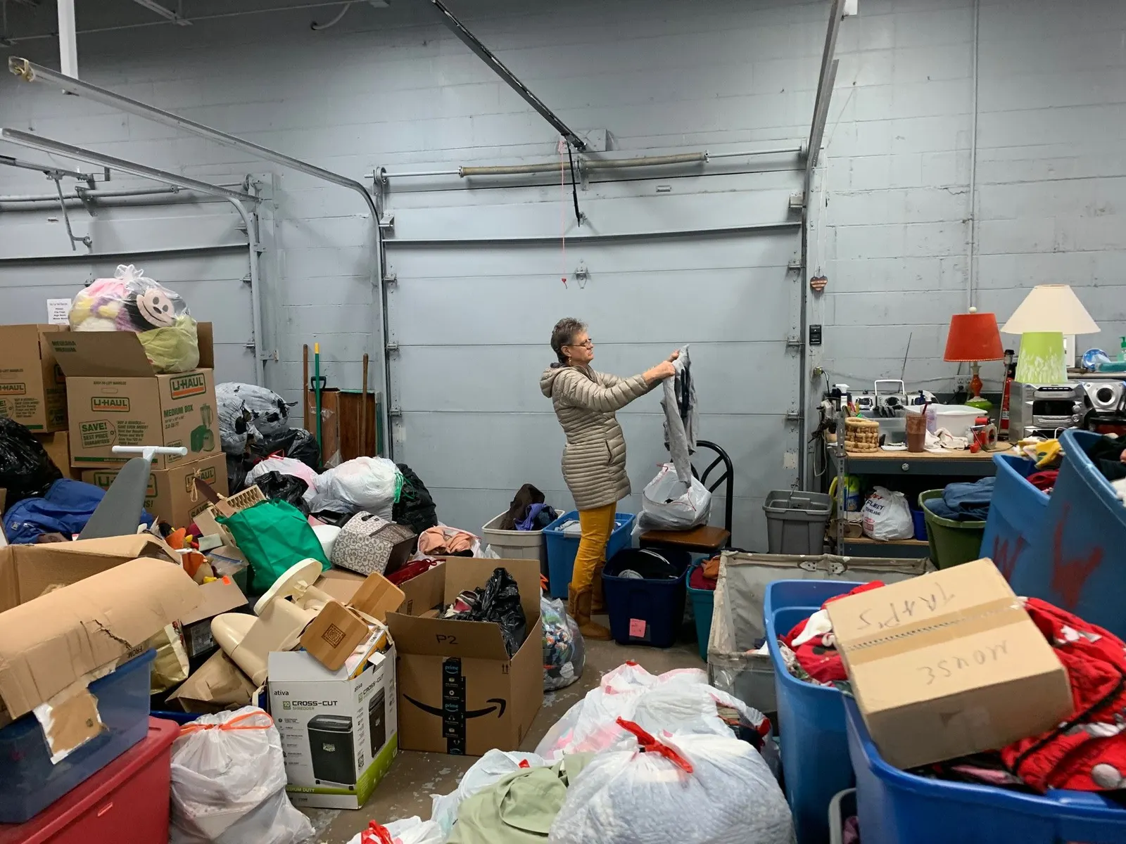 A volunteer sorting incoming donations in the receiving area