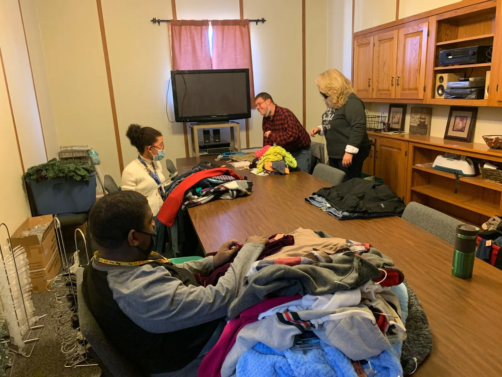 A team of volunteers sorting clothing together